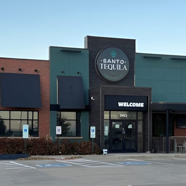 Exterior of Santo Tequila restaurant with a large circular sign and a "WELCOME" entrance.